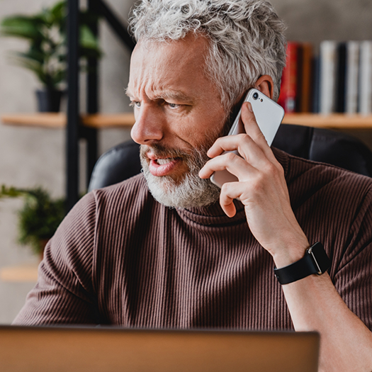 Bearded man talking on his cell phone