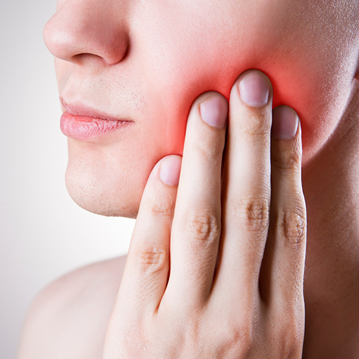 Woman with dental pain rubbing cheek