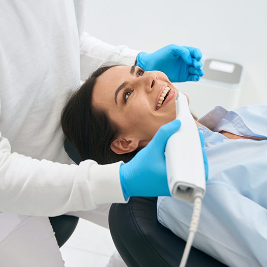 Dentist using technology to scan patients teeth