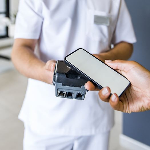 Holding a smartphone over another device to pay