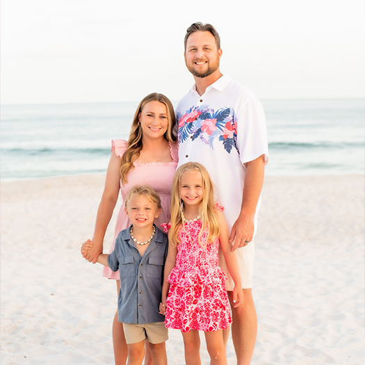 Dr Sharp with his family on a beach