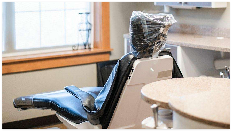 Dental chair with head covered with plastic