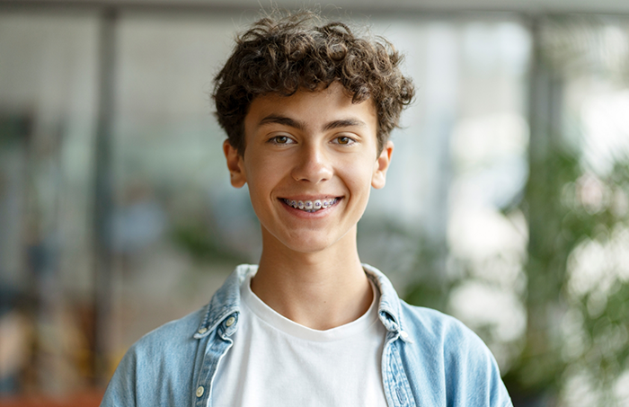 Teenage boy smiling with braces for orthodontic treatment in Fort Smith