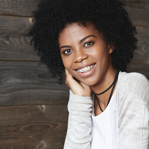 Smiling woman with white shirt and braces