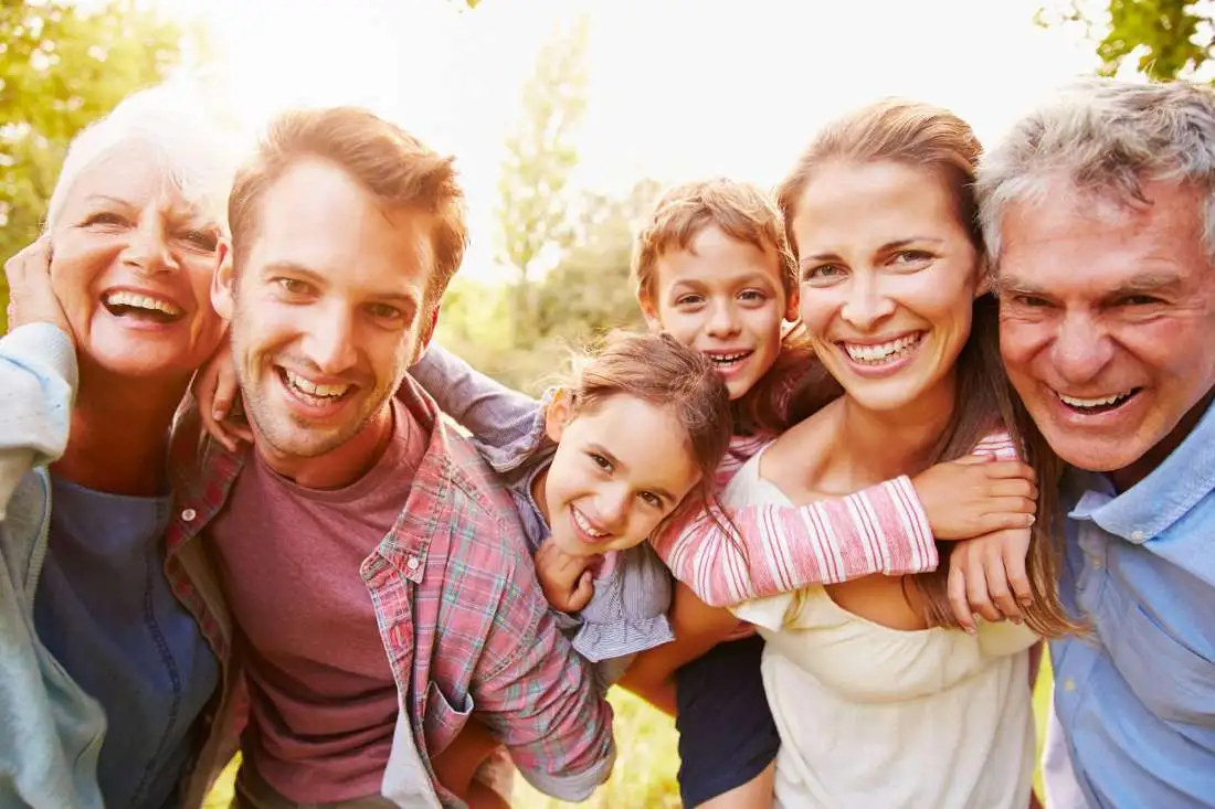 Entire family standing in circle and smiling