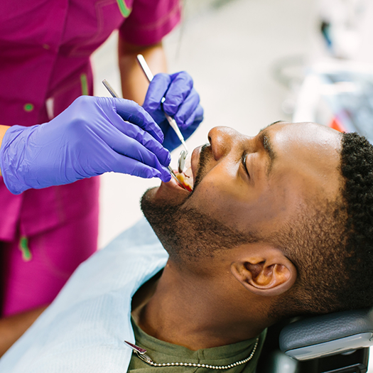 Man having teeth cleaned for preventive dentistry in Fort Smith